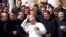 Pope Francis adjusts his skullcap as he poses with a group of priests during the weekly audience in Saint Peter's Square at the Vatican Sept. 28, 2016. The Pope's 2017 trip to Colombia will be his third to that country.