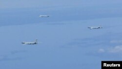 A Russian TU-95 bomber and Chinese H-6 bombers fly over East China Sea in this handout picture