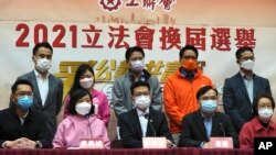 Members of pro-Beijing Hong Kong Federation of Trade Unions, including Stanley Ng Chau-pei, center in front, attend a press conference after winning the Legislative election in Hong Kong, Dec. 20, 2021. 