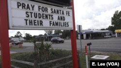 Businesses throughout the town of Santa Fe, Texas, post signs in support of the survivors and the loved ones of those killed in the high school shooting May 18, 2018.