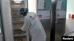 FILE - A nurse arranges bottles of human milk at the Pumwani Maternity Hospital in Nairobi, Kenya, Oct. 17, 2019. At least 41 employees at the hospital tested positive for the coronavirus, Kenya's Ministry of Health announced July 14, 2020.. 