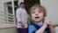 Adoption candidate Mark, 2, reacts in the children's department of a local hospital in Russia's Siberian city of Krasnoyarsk, March 23, 2011.