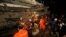 FILE - A rescue team searches for trapped workers at a collapsed building that was under construction in Kep, Cambodia, Jan. 3, 2020. 