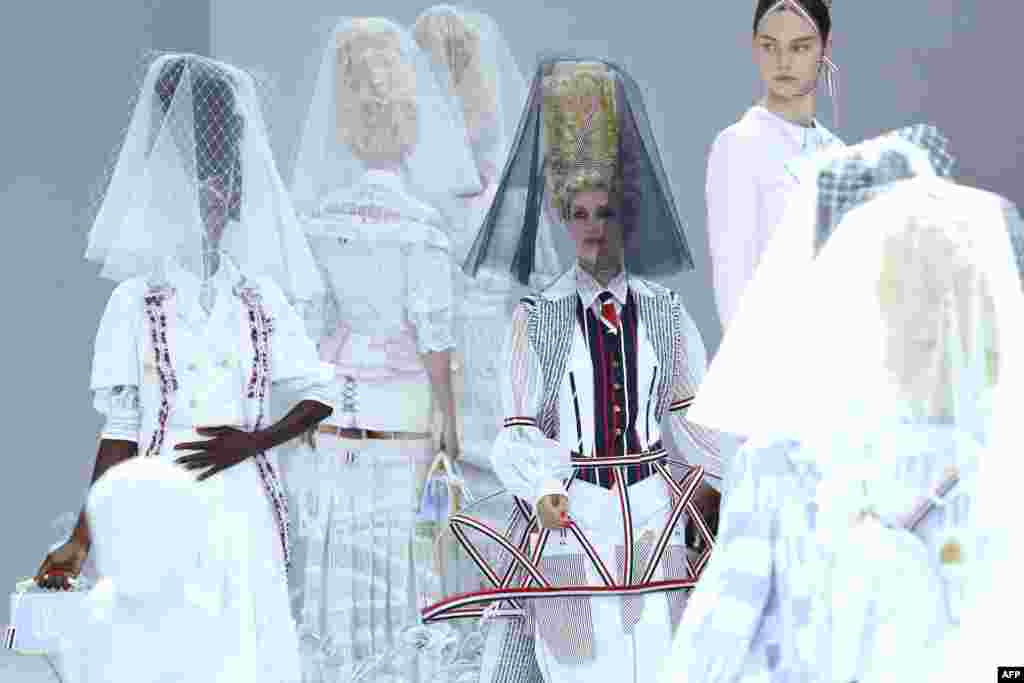 A model presents a creation by Thom Browne during the Women&#39;s Spring-Summer 2020 Ready-to-Wear collection fashion show at the Ecole nationale superieure des Beaux-Arts in Paris, France.