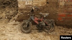 A children's bike leans against a wall covered in mud after rivers breached their banks due to torrential rains, causing flooding and widespread destruction in Carapongo Huachipa, Lima, Peru, March 24, 2017. 