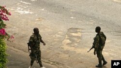 Armed pro-Gbagbo soldiers patrol the streets near the presidential palace in Abidjan, April 3, 2011