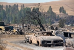 Vehicles destroyed by a wildfire are shown in Malden, Wash., Sept. 8, 2020.