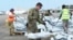 Members of the US army help load supplies at Beira International airport, Mozambique, Monday, April 1, 2019, joining the humanitarian aid efforts following a cyclone that hit the country on March 14. 