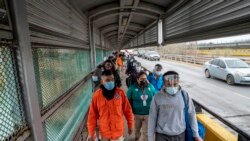 Migrants approach the U.S. border on Gateway International Bridge in Brownsville, Texas, on March 2, 2021.