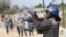 Armed Zimbabwean police battle rioters in Harare, July, 4, 2016. The violence came amid a surge in protests in recent weeks because of economic hardships and alleged mismanagement by the government of President Robert Mugabe.