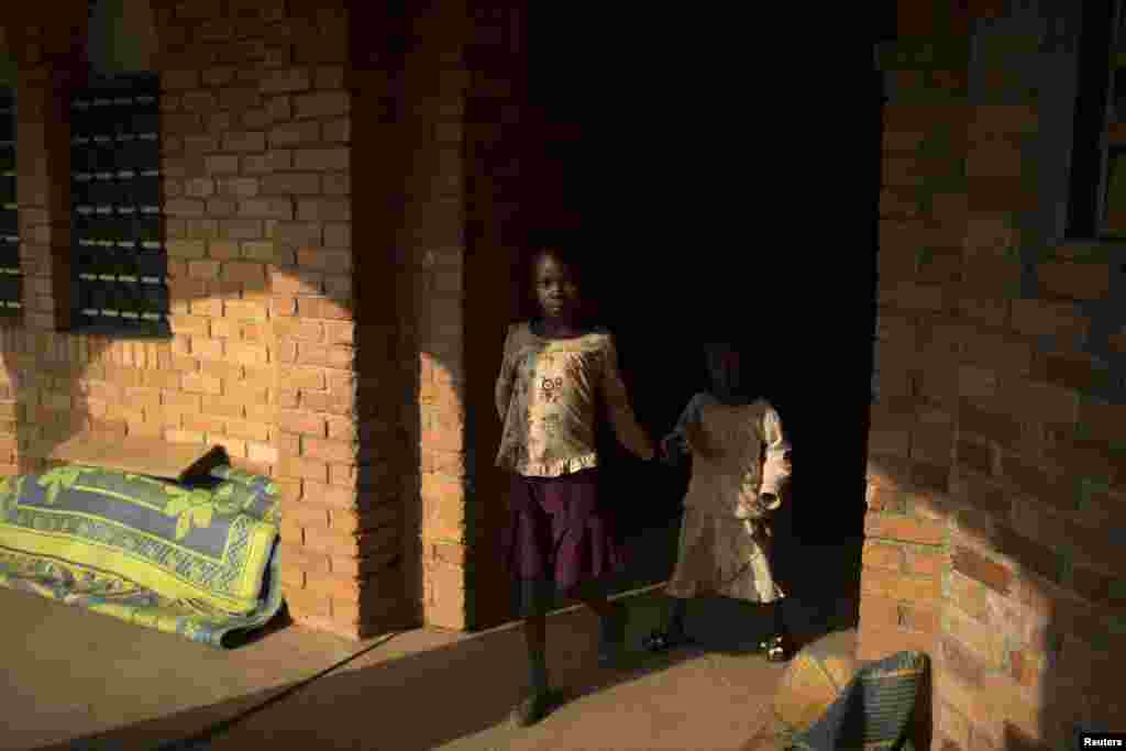 Girls walk in a monastery sheltering internally displaced persons in the district of Boy Rabe in Bangui, Feb. 4, 2014. 