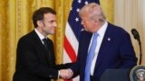 President Donald Trump, right, and France's President Emmanuel Macron shake hands during a joint press conference in the East Room of the White House in Washington, Monday, Feb. 24, 2025.
