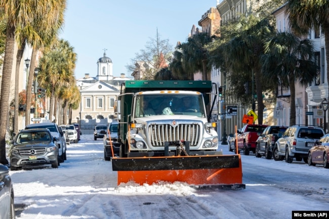 A City of Charleston snowplow clears Broad Street after a winter storm dropped ice and snow Wednesday, Jan. 22, 2025, on Charleston, S.C. (