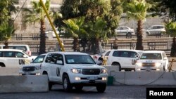 U.N. vehicles carrying a team of United Nations chemical weapons experts, are pictured as they return to their hotel in Damascus Aug. 26, 2013, after visiting one of the sites of an alleged poison gas attack. 