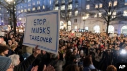 People protest against Elon Musk outside the Treasury Department in Washington, Feb. 4, 2025.