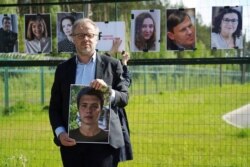 Reporters Sans Frontiers Secretary General Christophe Deloire holds a picture of detained Belarus blogger Raman Pratasevich at Salcininkai border crossing point, Lithuania on May 27, 2021.