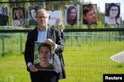 Reporters Sans Frontiers Secretary General Christophe Deloire holds a picture of detained Belarus blogger Raman Pratasevich at Salcininkai border crossing point, Lithuania on May 27, 2021.