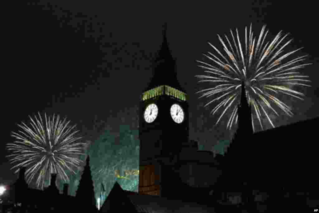 Fireworks explode behind the Houses of Parliament on the River Thames during New Year celebrations in London, Britain, 01 Jan 2011. (Reuters Image)