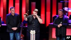 Vince Gill, left, and Joe Diffie, right, welcome Luke Combs to the Grand Ole Opry at "Luke Combs Joins the Grand Ole Opry Family," July 16, 2019, in Nashville, Tenn. 