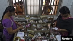 Pharmacists dispense free medication, provided by the government, to patients at Rajiv Gandhi Government General Hospital in Chennai, July 12, 2012. 