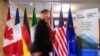 A man walk past the flags of G7 members countries at the Manoir Richelieu before a G7 foreign ministers meeting in La Malbaie, Quebec, Canada, March 12, 2025.