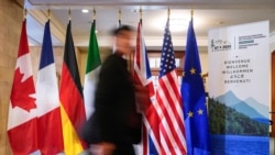 A man walk past the flags of G7 members countries at the Manoir Richelieu before a G7 foreign ministers meeting in La Malbaie, Quebec, Canada, March 12, 2025.