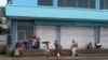 Locals gather outside closed shops in Honiara, Solomon Islands, Dec. 6, 2021. 