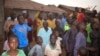 FILE - People gather around an area were gunmen kidnapped school children in Chikun, Nigeria, Thursday, March 7, 2024.