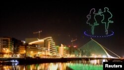 A display by Tourism Ireland entitled "Orchestra of Light" featuring a swarm of 500 drones is animated in the night sky above the Samuel Beckett bridge on the river Liffey for St Patrick's Day, as it is cancelled due to COVID-19, Dublin, March 7, 2021.