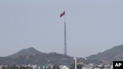 FILE - A North Korean flag flutters in the wind atop a tower in the North's Kijong-dong village near the truce village of Panmunjom in Paju, South Korea on Sept. 28, 2017. South Korea's spy agency said TJuly 16, 2024, that a North Korean diplomat based in Cuba