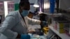 Técnicos de laboratorio analizan una muestra de sangre para detectar infección por VIH en el Instituto de Salud Reproductiva y VIH (RHI) en Johannesburgo, el jueves 26 de noviembre de 2020.