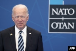 U.S. President Joe Biden arrives to be greeted and pose for a photograph with NATO Secretary General Jens Stoltenberg during the NATO summit at the North Atlantic Treaty Organization's headquarters, in Brussels, June 14, 2021.