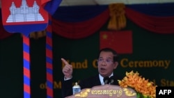 Cambodia’s Prime Minister Hun Sen speaks during a handover ceremony of the Morodok Techo National Stadium, funded by China's grant aid under its Belt and Road Initiative, in Phnom Penh on September 12, 2021. (Photo by TANG CHHIN Sothy / POOL / AFP)