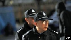 Policemen patrol outside the apartment complex where jailed Nobel peace laureate Liu Xiaobo's wife lives in Beijing, 10 Dec 2010