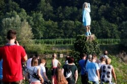 The blocky figure of Melania Trump was cut from the trunk of a living linden tree, whose base forms a tall plinth in a field beside the Sava River in Rozno, eight km (five miles) from Sevnica, Slovenia. July 5, 2019.