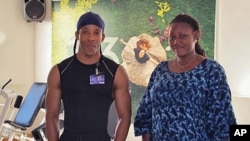 Fitness trainer Mickael Lafarge and one of his clients, Aissatou Sidime, before working out at a local gym in Dakar, Senegal, January