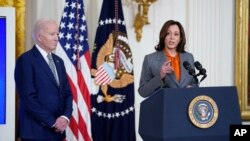 FILE - President Joe Biden listens as Vice President Kamala Harris speaks during an event on artificial intelligence systems in the East Room of the White House, Monday, Oct. 30, 2023, in Washington.