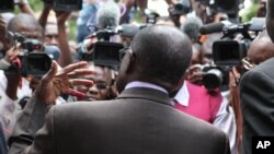 Zimbabwean President Robert Mugabe talks to the press after casting his vote during the country's referendum in the capital Harare, March, 16, 2013.