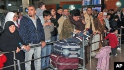 A Jordanian woman evacuated from Tripoli is received by her family as she arrives in Queen Alia Airport near Amman, Jordan, February 21, 2011