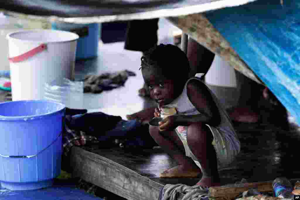 A migrant child peeks out of a tent at a camp in Lajas Blancas, Darien province, Panama.