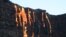 FILE - Lava from Kilauea, an active volcano on Hawaii's Big Island, flows into the ocean as seen from a boat off the coast of Volcanoes National Park near Kalapana, Hawaii, Aug. 9, 2016. 