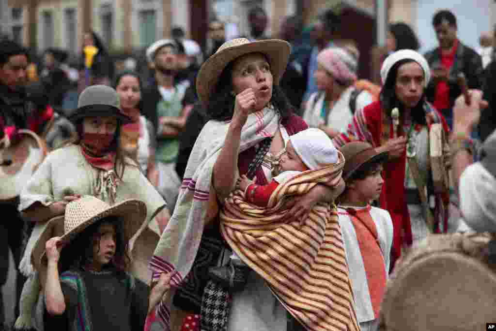 A woman marches with her children in an anti-government demonstration in Bogota, Colombia.