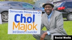 FILE - Chol Majok is seen with a primary election campaign sign in a photo from his Facebook campaign page.