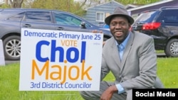 FILE - Chol Majok is seen with a primary election campaign sign in a photo from his Facebook campaign page.