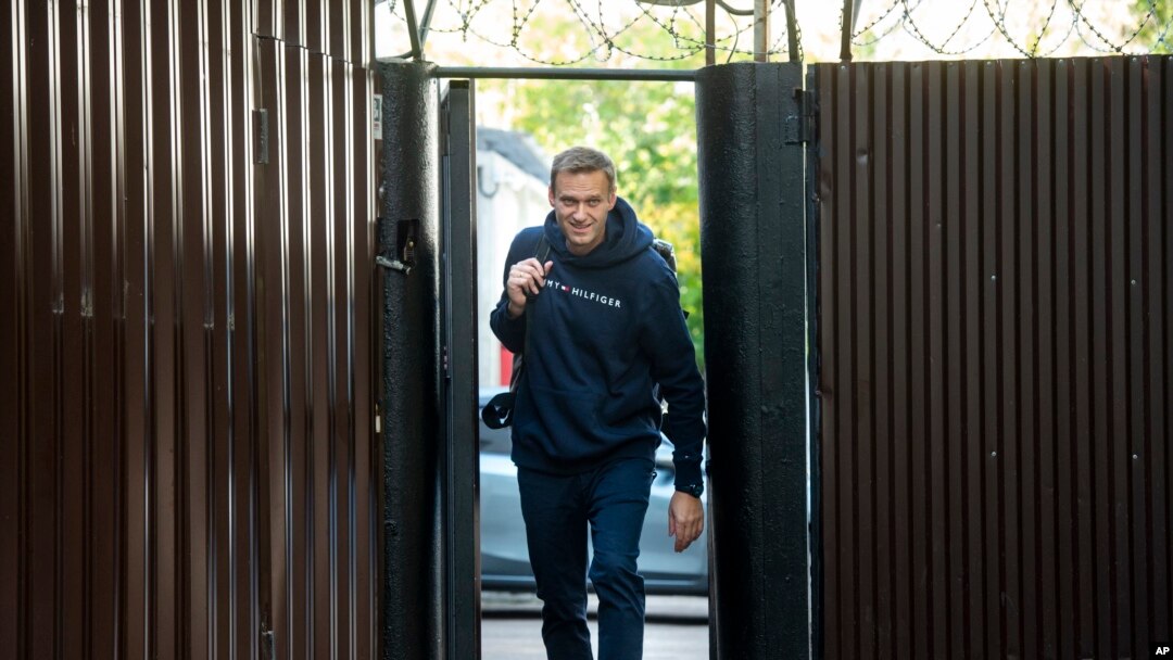 Russian opposition leader Alexei Navalny leaves a detention center after his release, in Moscow, Russia, Friday, Aug. 23, 2019.