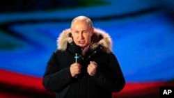 Russian President Vladimir Putin speaks during a rally near the Kremlin in Moscow, Sunday, March 18, 2018. 