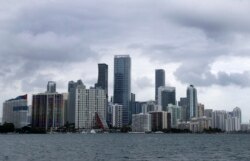 FILE - Clouds loom over the Miami skyline May 14, 2020, the early signs of what would become Tropical Storm Arthur.