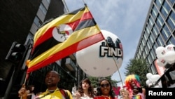 FILE - People from Uganda participate in the annual Pride London parade which highlights issues of the gay, lesbian and transgender community, London, June 29, 2013.