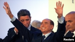 FILE - Forza Italia party leader Silvio Berlusconi waves as he leaves at the end of a rally in Catania, Italy, Nov. 2, 2017. 