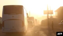 Buses carrying Jaish al-Islam fighters and their families, from the former rebel bastion's main town of Douma, arrive in the Syrian town of Azaz, April 5, 2018, on their way to a refugee camp.